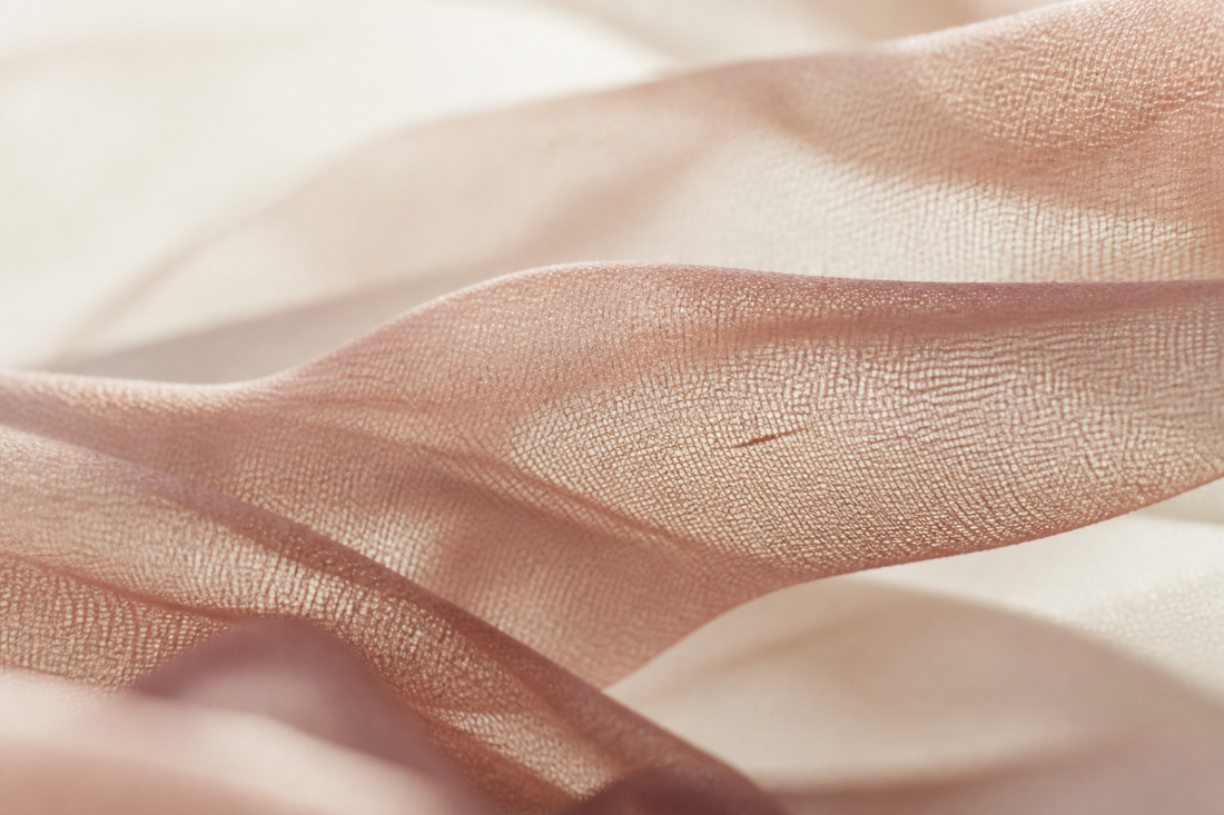 Fine translucent lace mesh backlit, draped in soft folds